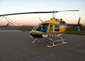 A training helicopter sitting on the runway